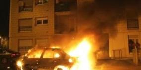 مستوطنون يحرقون مركبة وجرارا زراعيا ويخطون شعارات عنصرية في بيت أمر